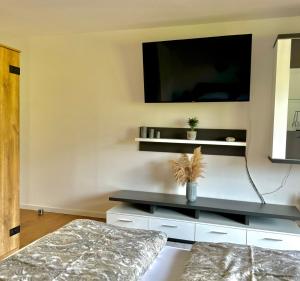 a living room with a tv on the wall at Haus Landzauber in Ramsau am Dachstein