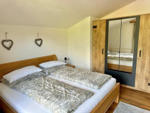 a bedroom with a bed and a large mirror at Haus Landzauber in Ramsau am Dachstein