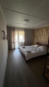 a bedroom with a large bed and a window at HIT- house in Slavske +37 photos