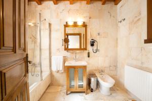 a bathroom with a sink and a toilet and a shower at Pazo Arretén in Padrón