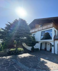 a white house with a tree in front of it at Haus Landzauber in Ramsau am Dachstein
