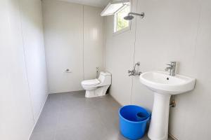 a bathroom with a sink and a toilet at Snowpeak Retreat in Hundar