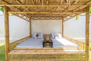 a bed in a wooden pergola with a table at Villa GAÏA - Luxury Tropical Villa - Private Pool in Lamai +14 photos