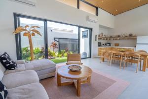 a living room with a couch and a table at Villa GAÏA - Luxury Tropical Villa - Private Pool in Lamai