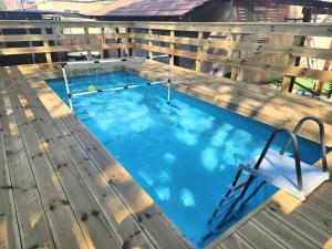 a large swimming pool on top of a wooden deck at וילה נחל טביה in Arad