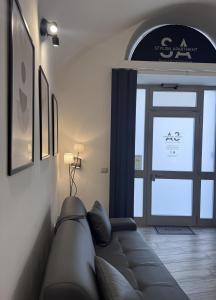 a living room with a couch and a window at Norcia Stylish Apartment in Norcia +36 photos