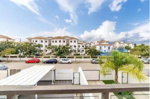 a view of a parking lot with white buildings at Chalet Adosado en Playa La Barrosa in Novo Sancti Petri