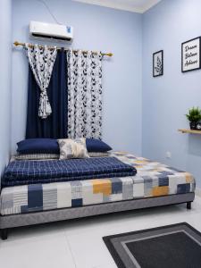 a bed sitting in a room with a curtain at Bkc Home's 101 in Mataram