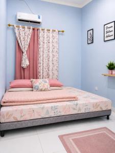 a bedroom with a bed with a pink curtain at Bkc Home's 101 in Mataram