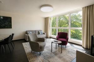 a living room with a couch and chairs and a table at Grand Apartment Sissi in Trieste