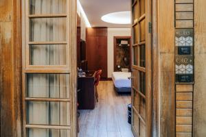 a bathroom with wooden doors and a sink at Henna Hotel Istanbul in Istanbul