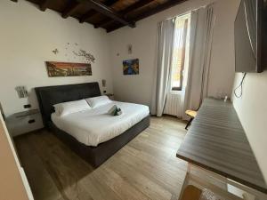 a bedroom with a bed and a wooden floor at Poste Regie - Milan Guest House in Milan