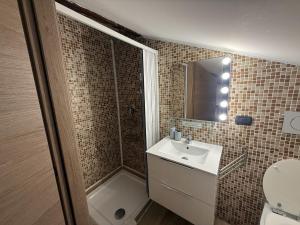 a bathroom with a toilet and a sink and a shower at Poste Regie - Milan Guest House in Milan +10 photos