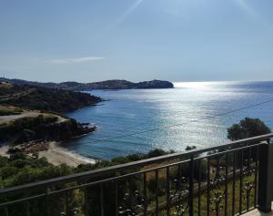 a view of the ocean from a balcony at Aegean Beachfront Apartments in Petriaí
