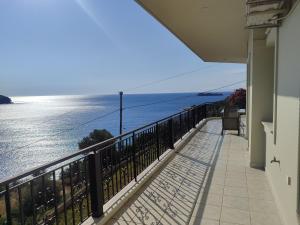 a balcony with a view of the water at Aegean Beachfront Apartments in Petriaí