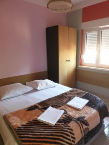 a bedroom with a bed with two white towels on it at Apartments Drago in Petrcane