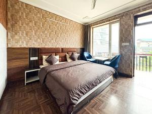 a bedroom with a bed and a table and chairs at Young Monk Hostel Bhagsu,Mcleodganj in Dharamshala