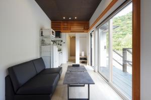 a living room with a couch and a table at SEN RETREAT HONGU - Kumano Kodo Gateway in Tanabe