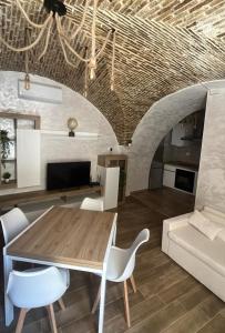 a kitchen and living room with a wooden table and chairs at Mercato29Home in Lucera