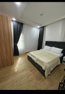 a bedroom with a large bed in a room at Executive Apartment in Anthony in Lagos +5 photos