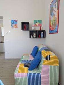 a bedroom with a bed with blue pillows on it at Villa Carbonilla in Torre del Greco