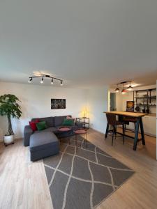 a living room with a couch and a table at Apartment Am Wald in Idar-Oberstein