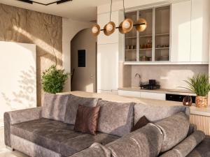 a living room with a couch and a kitchen at Anemolia Villas in Karpathos