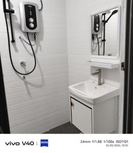 a bathroom with a shower with a sink and a phone at Ciao Bella in Dungun +11 photos