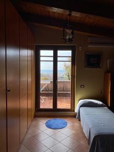 a room with two beds and a large window at B&B LA ROSA in Salerno