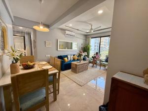 a living room with a table and a blue couch at Fortune 603 in Mumbai