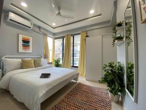 a bedroom with a white bed and a rug at Fortune 603 in Mumbai