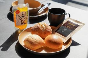 a plate of food with donuts on a table at SEN RETREAT HONGU - Kumano Kodo Gateway in Tanabe +20 photos