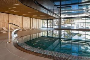 a swimming pool in a building with a large window at WAVE Seaview in Międzyzdroje +17 photos