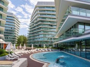 a swimming pool in front of a large building at WAVE Seaview in Międzyzdroje