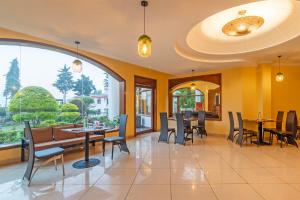 a dining room with yellow walls and tables and chairs at Treebo Kaler Hotel & Resorts in Nainital