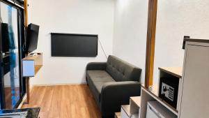 a living room with a couch and a flat screen tv at Alya Hill Bodrum in Bodrum City
