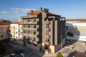 a tall building with a red roof at Made Inn Entroncamento in Entroncamento