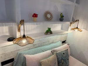 a room with white shelves with pillows and lamps at Puerto de Jávea in Jávea