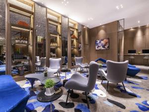 a salon with chairs and a blue couch at Mercure Kunshan Hi Tech Zone in Kunshan