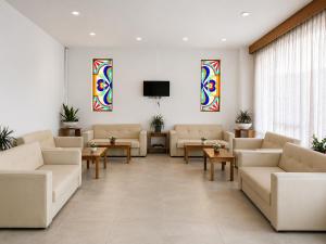a waiting room with couches and stained glass windows at Smart Accomodation Rhodes by GHH in Rhodes Town