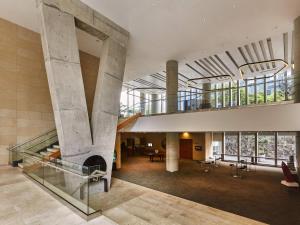 a lobby of a building with a fireplace at Pullman Lima San Isidro in Lima