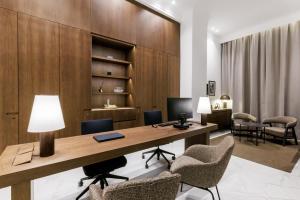 an office with a desk with chairs and a computer at Apartments Kozmo Residences Budapest in Budapest