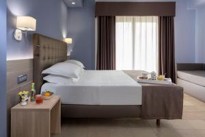 a bedroom with a large white bed and a window at Netum Hotel in Noto +100 photos