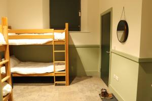 a room with two bunk beds and a mirror at Ashbourne Gateway Lodge in Ashbourne +10 photos