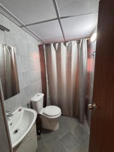 a bathroom with a toilet and a sink at Pool View 3 BR Adora, Goa Amoret Homes in Chicalim +8 photos