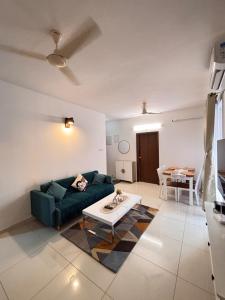 a living room with a green couch and a table at Pool View 3 BR Adora, Goa Amoret Homes in Chicalim