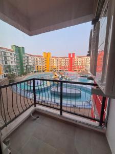 a balcony with a view of a swimming pool at Pool View 3 BR Adora, Goa Amoret Homes in Chicalim