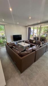 a large living room with couches and a television at Pili Beach Resort Agmanic in Santa Fe
