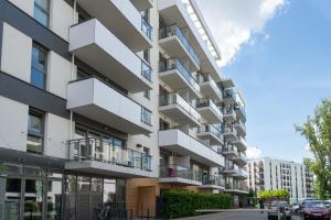 an apartment building with balconies on a street at apartamenty-wroc Central Park in Wrocław