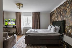 a hotel room with a bed and a window at Söderfors Herrgård in Söderfors